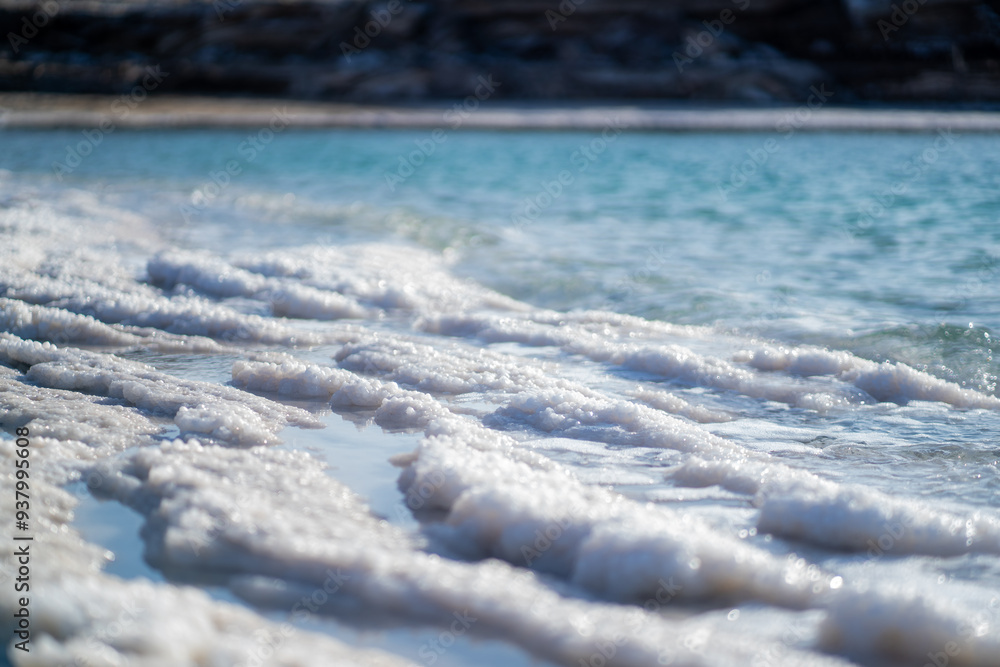 Obraz premium Crystallized white salt on the coast of a Dead sea closeup.