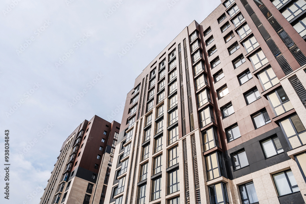 The facade of a new apartment building against the sky . The facade of a new apartment building against the sky .