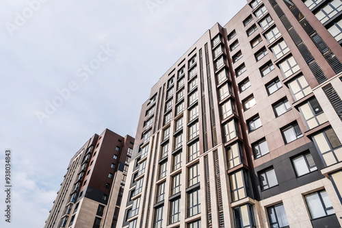 The facade of a new apartment building against the sky .