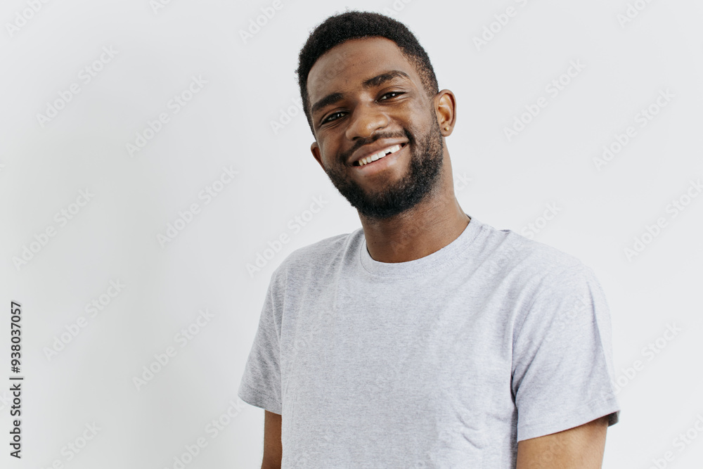 Confident african american man in casual grey tshirt standing against a white background, radiating positivity and warmth Confident african american man in casual grey tshirt standing against a white background, radiating positivity and warmth