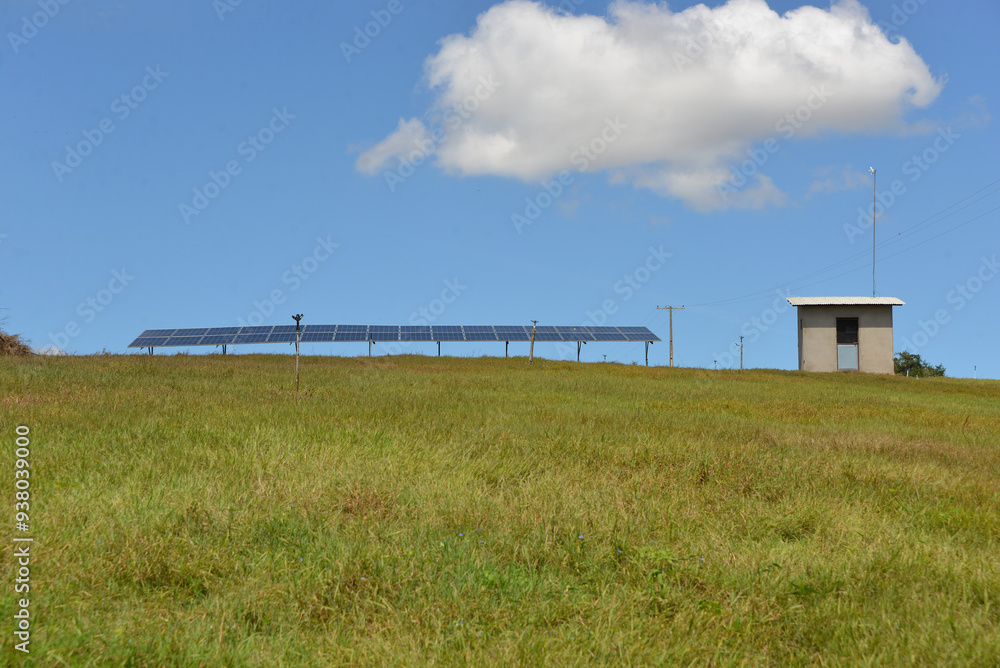 Open space solar panels installation with photovoltaic modules on a hay field in rural farm on sunny day. Open space solar panels installation with photovoltaic modules on a hay field in rural farm on sunny day.