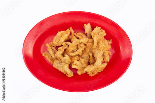 Krispi Fried Oyster Mushrooms or Krispi Mushrooms. Oyster mushrooms wrapped in seasoned flour and dry fried. fried mushrooms on a red plate with a white background. photo