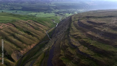 Aerial footage which emphasizes the river's journey as it carves its way through Arncliffe, highlighting the natural contrasts and beauty	 photo