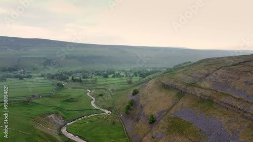 Aerial footage which emphasizes the river's journey as it carves its way through Arncliffe, highlighting the natural contrasts and beauty	 photo