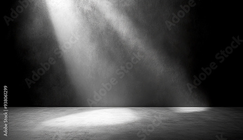 A plain gray wall with a spotlight shining on it, creating an empty space for product display or background