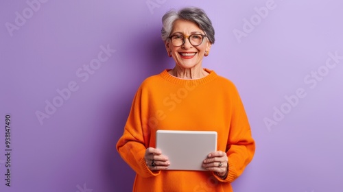 The elderly woman with tablet photo