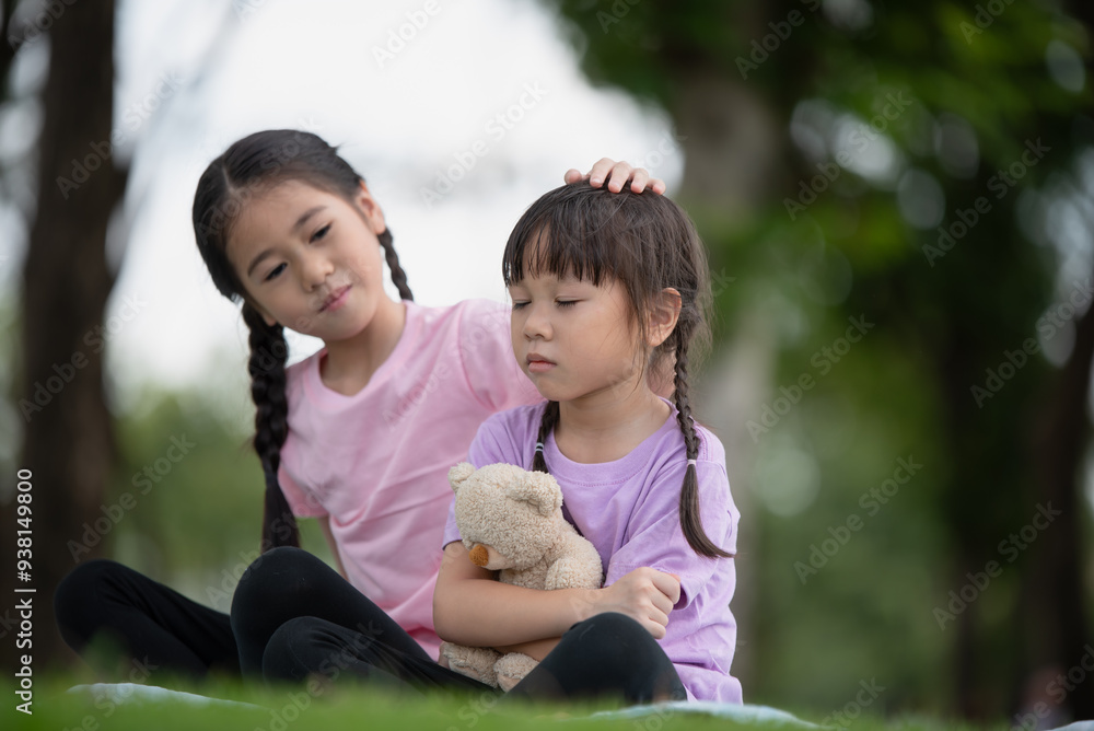 Asian family children elder sister comforts her younger sister Asian family children elder sister comforts her younger sister