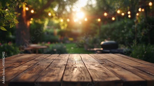 Sunlit wooden table in a garden with string lights during golden hour