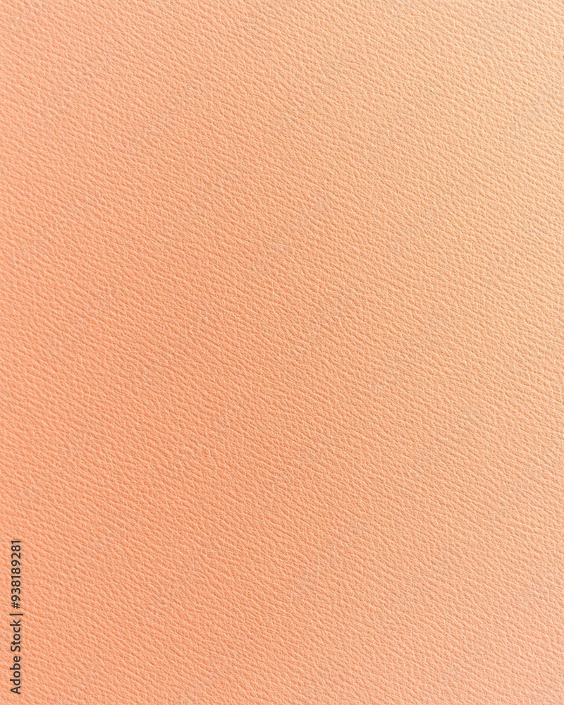 Fototapeta premium Soft peach textured background featuring a smooth gradient for creative design