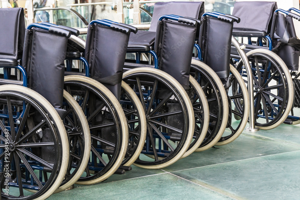 Wheelchairs lined up inside the airport in Catania, Italy. Concept of mobility and accessibility. Wheelchairs lined up inside the airport in Catania, Italy. Concept of mobility and accessibility.