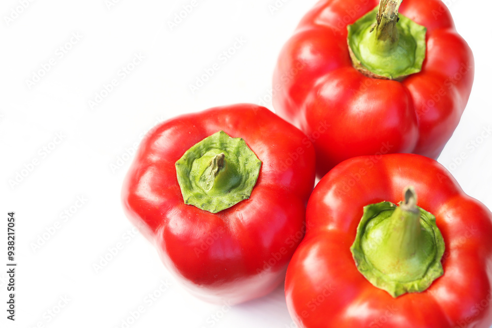 Red bell peppers isolated on a white. Empty copy space food bacground. Homegrown in a backyard garden vegetables. Fresh and organic food. Healthy eating and sustainable living. Shiny paprika. Red bell peppers isolated on a white. Empty copy space food bacground. Homegrown in a backyard garden vegetables. Fresh and organic food. Healthy eating and sustainable living. Shiny paprika.