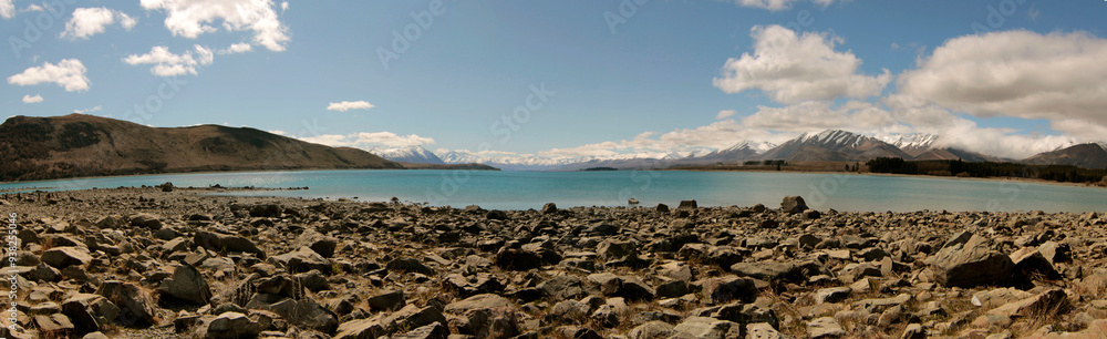 panorama of a scenic view of a lake with mountains and snow at sunset panorama of a scenic view of a lake with mountains and snow at sunset