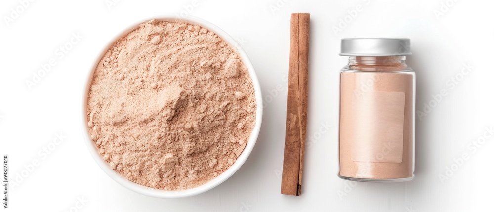 A jar of cinnamon powder sits next to a bowl of powder A jar of cinnamon powder sits next to a bowl of powder