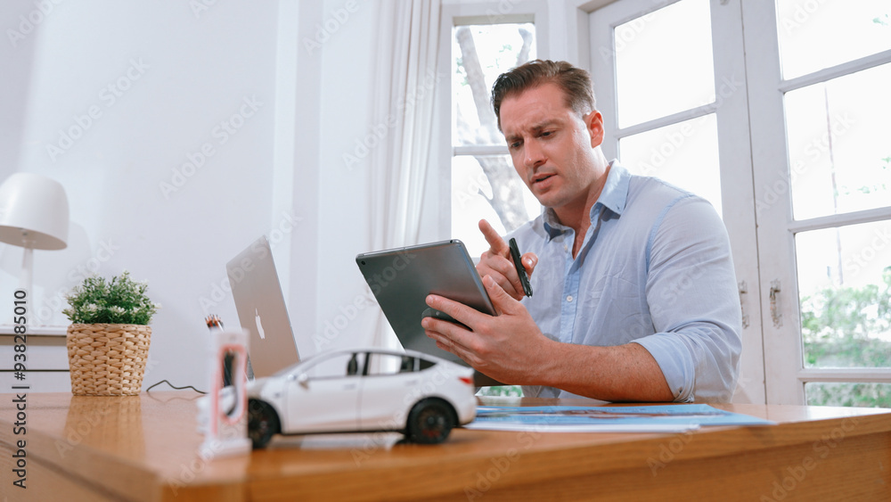 Stressed and frustrated car design engineer put his head in his hand after discover flaw in vehicle design, working at home for automotive business while trying to find solution. Synchronos Stressed and frustrated car design engineer put his head in his hand after discover flaw in vehicle design, working at home for automotive business while trying to find solution. Synchronos