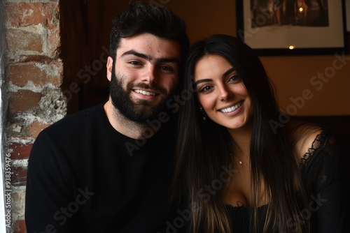 A joyful couple enjoying a cozy moment inside a charming café filled with warm ambiance, soft lighting, and rustic brick walls on a serene afternoon