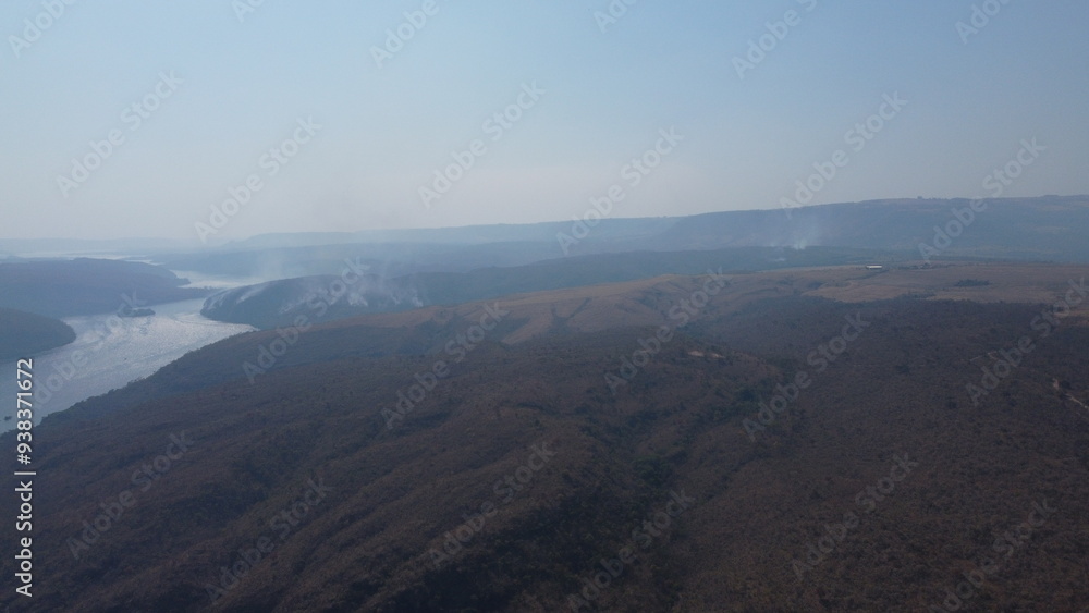 Fototapeta premium Nature's Fury: Drone Footage of Wildfire on Hills and River at São Paulo-Minas Gerais Border