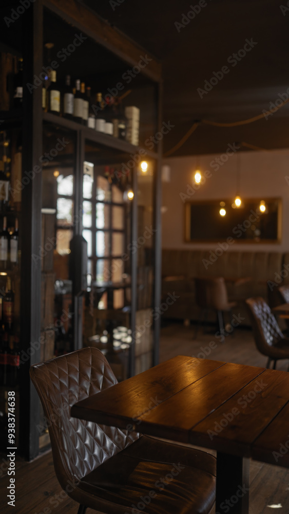 Cozy restaurant interior with wooden tables, leather chairs, wine bottles, warm lighting, and a relaxed atmosphere Cozy restaurant interior with wooden tables, leather chairs, wine bottles, warm lighting, and a relaxed atmosphere