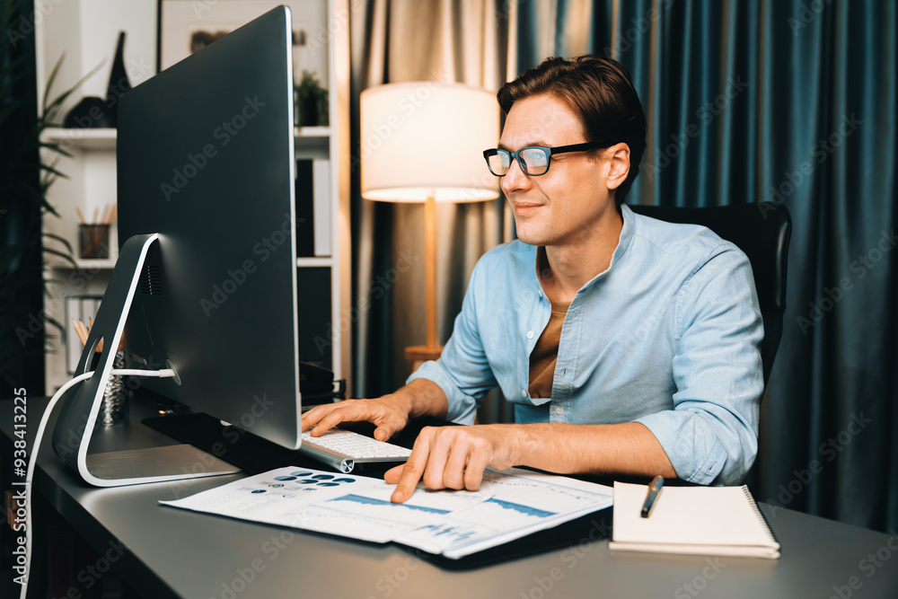 Smart businessman analyzing business paragraph dynamic database marketing analysis plan surrounded paper sheet and pc monitor report to compare with document data at home office at night. Pecuniary. Smart businessman analyzing business paragraph dynamic database marketing analysis plan surrounded paper sheet and pc monitor report to compare with document data at home office at night. Pecuniary.