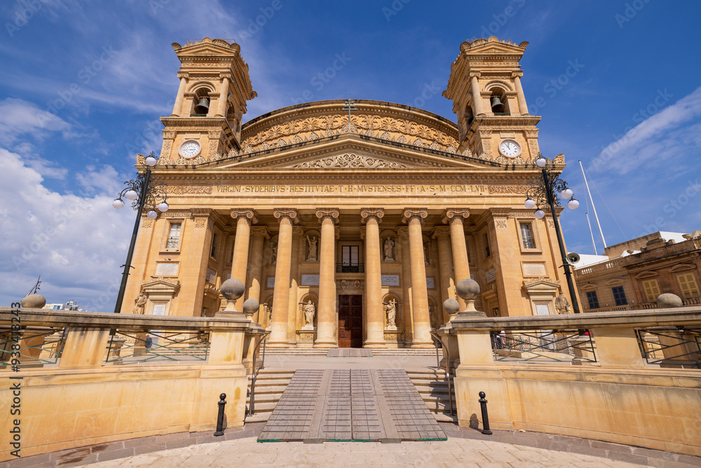 Malta, Mosta. Sanctuary Basilica of the Assumption of Our Lady, commonly known as the Rotunda of Mosta or the Mosta Dome, is a Roman Catholic parish church and basilica. Malta, Mosta. Sanctuary Basilica of the Assumption of Our Lady, commonly known as the Rotunda of Mosta or the Mosta Dome, is a Roman Catholic parish church and basilica.
