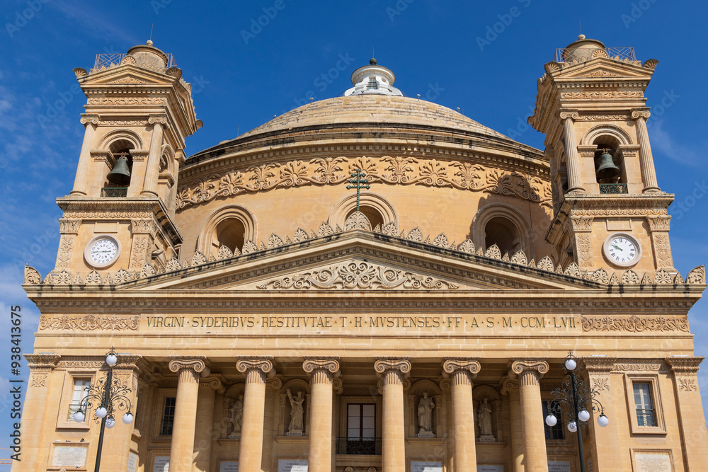 Malta, Mosta. Facade of the Sanctuary Basilica of the Assumption of Our Lady or Rotunda of Mosta. Dome, bell towers, pediment, Ionic columns. Third-largest unsupported dome in the world. Malta, Mosta. Facade of the Sanctuary Basilica of the Assumption of Our Lady or Rotunda of Mosta. Dome, bell towers, pediment, Ionic columns. Third-largest unsupported dome in the world.