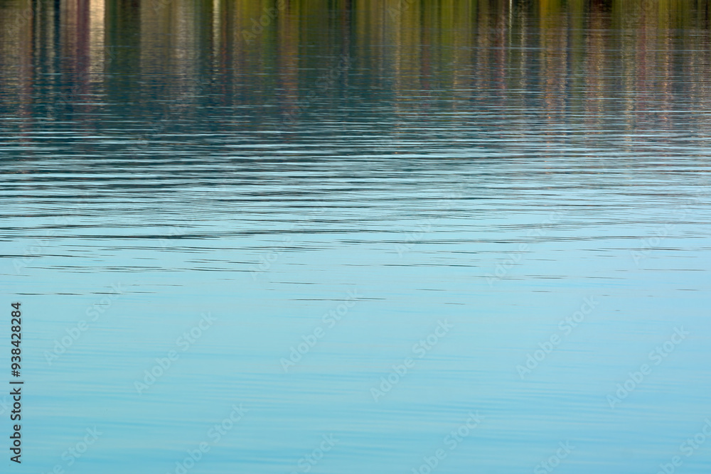 Complete calm on the water, in the sea, ocean, lake. Calm firs noticeable waves sparkle. The view goes into the distance with a haze in the background. Morning, afternoon or evening. Balaton, Hungary Complete calm on the water, in the sea, ocean, lake. Calm firs noticeable waves sparkle. The view goes into the distance with a haze in the background. Morning, afternoon or evening. Balaton, Hungary
