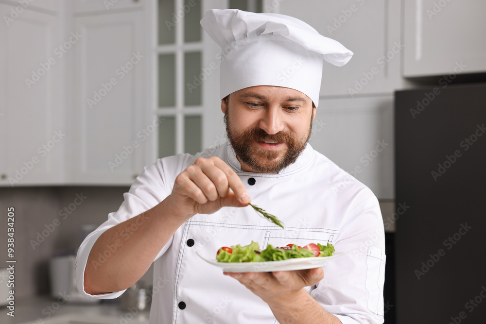 Professional chef decorating delicious dish with rosemary in kitchen Professional chef decorating delicious dish with rosemary in kitchen