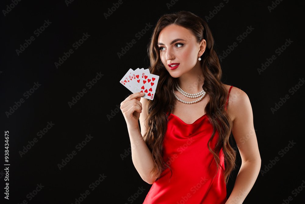 Poker game. Charming woman with playing cards on black background. Space for text Poker game. Charming woman with playing cards on black background. Space for text