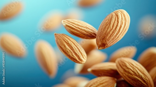 Falling Almonds on Subtle Blue Background