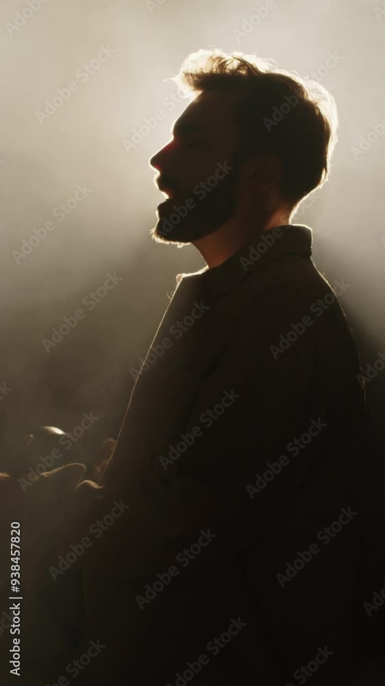 Vertical zoom shot of musician singing song and playing electric guitar while performing on stage during concert Vertical zoom shot of musician singing song and playing electric guitar while performing on stage during concert