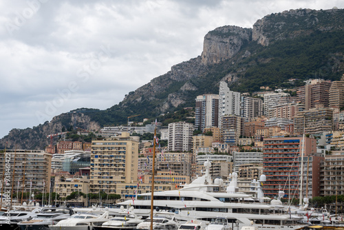 Walking in port of Monte-Carlo city in Monaco principality, houses and yacht boats, touristic destination on Mediterranean Sea