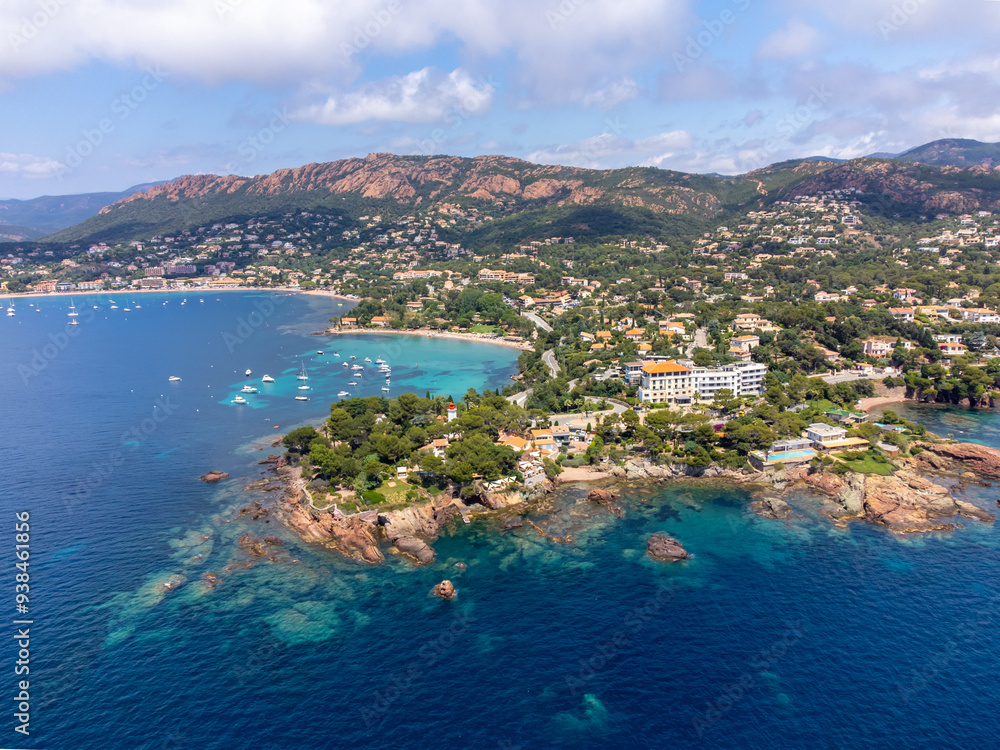 Fototapeta premium Panoramic view from above on blue Mediterranean dea, sandy beach of Agay town, summer vacation destination near Esterel mountains, French Riviera, Provence. France