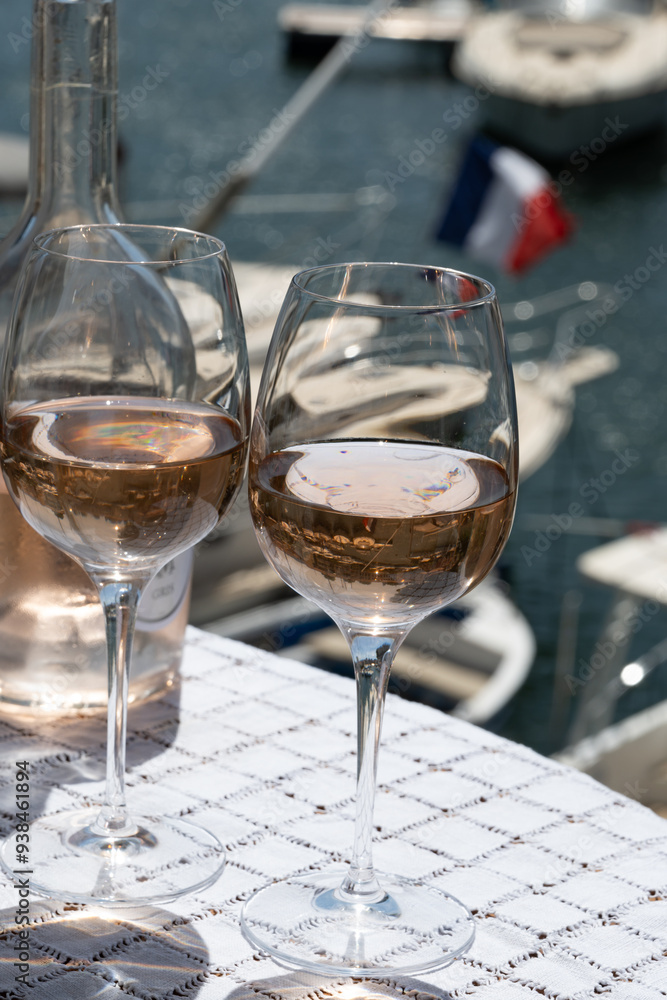Obraz premium Glasses of cold rose gris Cote de Provence wine in yacht harbour of Port Grimaud, summer vacation on French Riviera in Provence, France