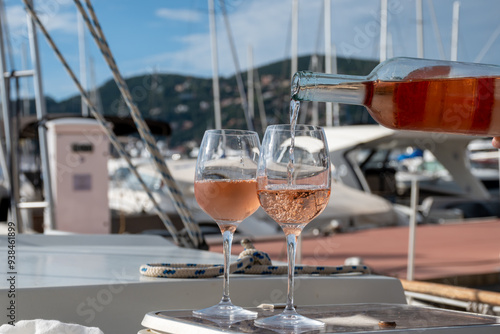 Party with rose wine on yacht boat anchored in port la Rague, Gulf of La Napoule, in Provence, two glasses of cold rose wine, French Riviera near Cannes, south of France photo