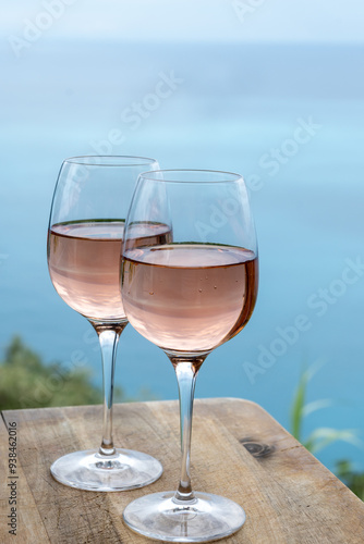 Summer time in Provence, two glasses of cold rose wine with blue sea view on background, French Riviera near Menton, south of France