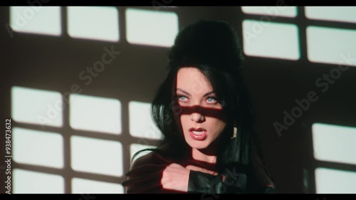 Woman looks up and blows a kiss and waves goodbye