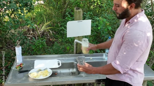 Wallpaper Mural Man preparing pineapple juice during picnic in park. Close up. zoom in Torontodigital.ca