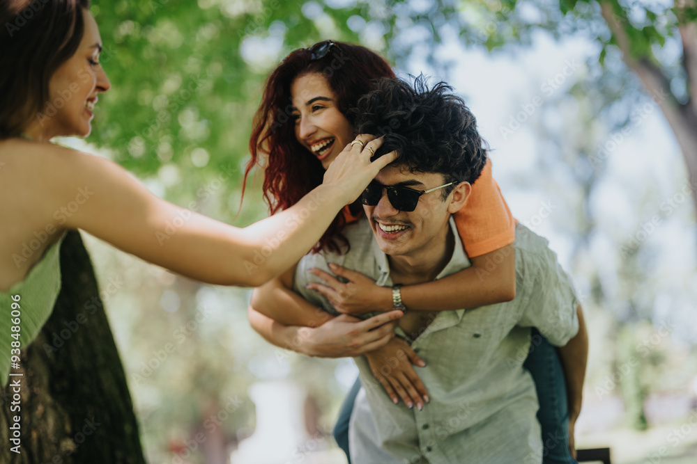 Three young adults having a fun time in a sunny park, sharing joy and laughter together. Three young adults having a fun time in a sunny park, sharing joy and laughter together.
