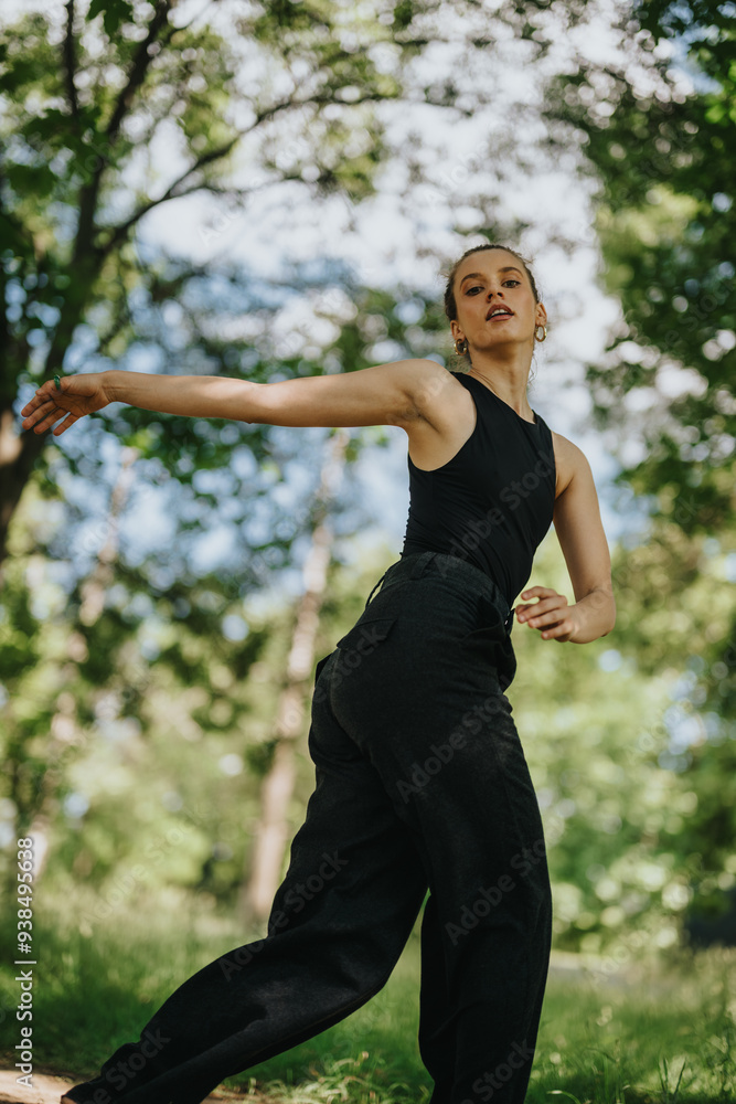 Lovely girl dancing and performing modern dance in nature surrounded by beautiful trees Lovely girl dancing and performing modern dance in nature surrounded by beautiful trees