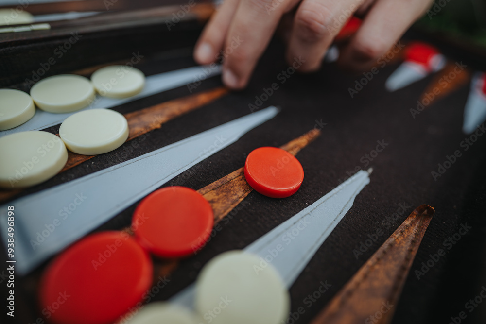 Detailed view of a backgammon board with red and white pieces, capturing a moment of strategic game play. Perfect for concepts of leisure and strategy. Detailed view of a backgammon board with red and white pieces, capturing a moment of strategic game play. Perfect for concepts of leisure and strategy.