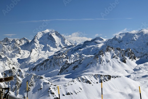 Snowcapped Alpine mountain peaks in the Three Valleys, France. Breathtaking view from popular Courchevel ski resort located in French Tarentaise Valley.