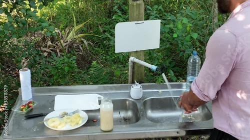 Wallpaper Mural Man preparing pineapple juice during picnic in park. Close up. zoom in Torontodigital.ca