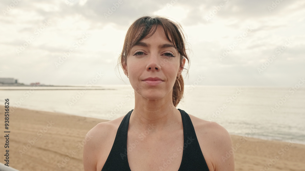 Portrait of european girl in sportswear against the sea, fit woman portrait looks at camera Portrait of european girl in sportswear against the sea, fit woman portrait looks at camera