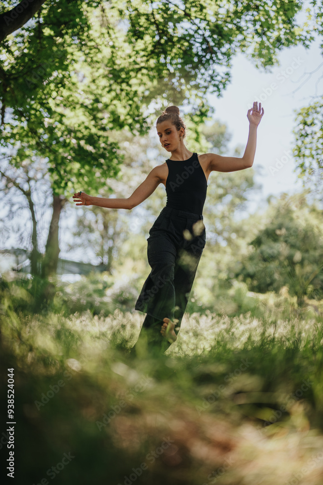 Lovely girl dancing in nature, female dancer performing modern dance in a sunlit forest surrounded by trees and greenery Lovely girl dancing in nature, female dancer performing modern dance in a sunlit forest surrounded by trees and greenery