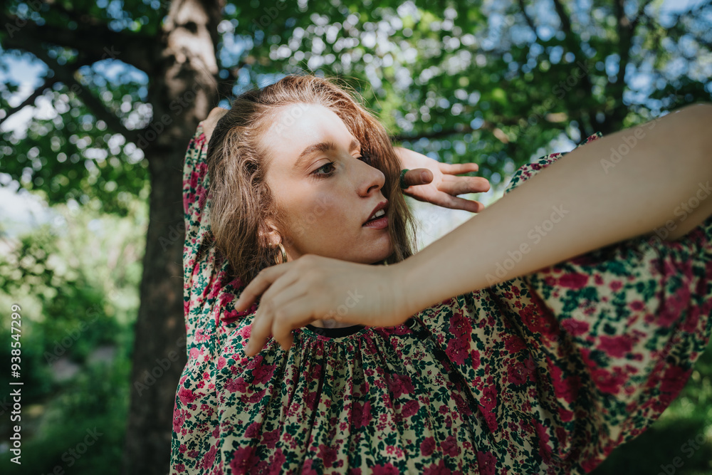 A young girl performing modern dance in a natural setting, wearing a floral dress with sunlight filtering through the trees. A young girl performing modern dance in a natural setting, wearing a floral dress with sunlight filtering through the trees.