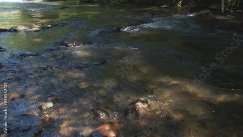 the small natural waterfall flows down from the mountain.clear and cool outdoor waterfall with rocks and trees all around.Places for relaxation in Thailand,