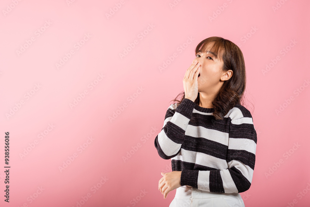 Portrait Asian beautiful young woman emotions tired and sleepy her yawning covering mouth open by hand, studio shot isolated on pink background, Thai female insomnia concept with copy space Portrait Asian beautiful young woman emotions tired and sleepy her yawning covering mouth open by hand, studio shot isolated on pink background, Thai female insomnia concept with copy space