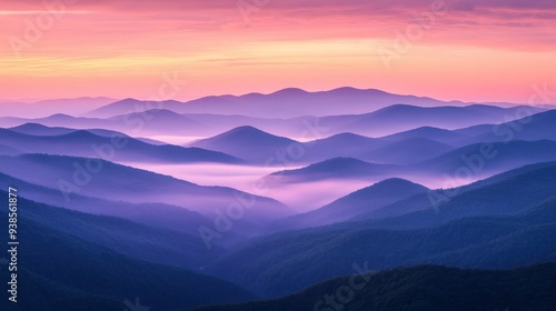 Serene Purple Mountains at Sunrise with Misty Layers and Pink Sky.