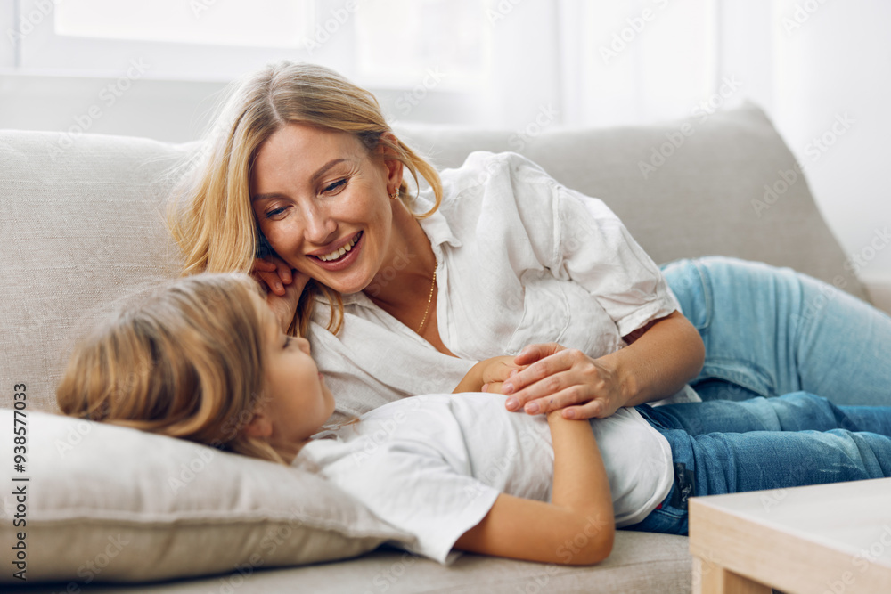 Mother and daughter bonding moment on the couch, hands gently intertwined, sharing a quiet, loving embrace Mother and daughter bonding moment on the couch, hands gently intertwined, sharing a quiet, loving embrace