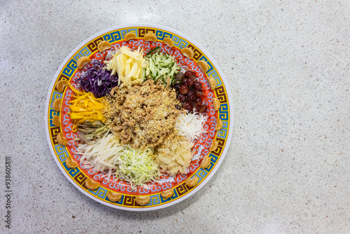 Serving of vegetarian Yusheng dish consisting vegetables and fruits for healthier diet during Chinese New Year celebration in Malaysia, suitable for vegan. photo