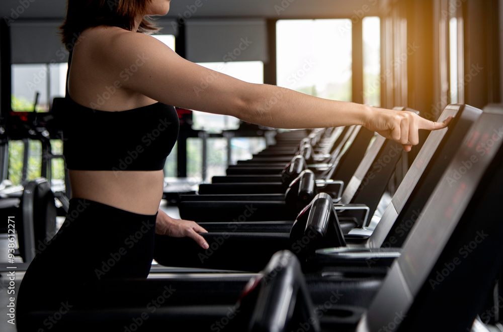photo portrait of a young woman exercise in gym, running use thereadmill machine equipment, healthy lifestyle, cardio exercise in fitness club concepts.